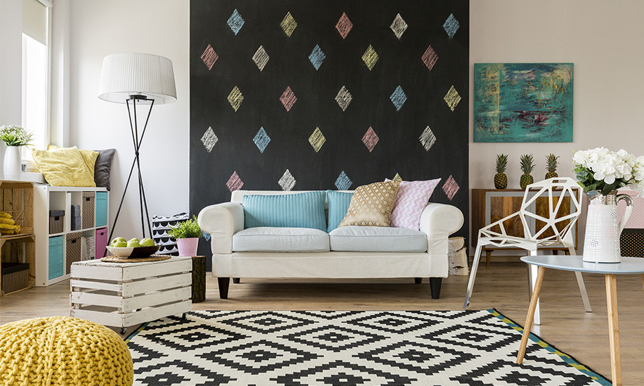 An accent wall ideas for living room, a sofa behind chalkboard accent wall is a fun design and looks vibrant