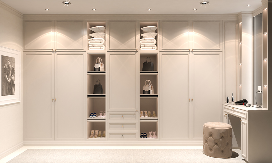 White laminated wooden wardrobe with dressing table with LED strip lighting shelves is a modern yet classic twist.