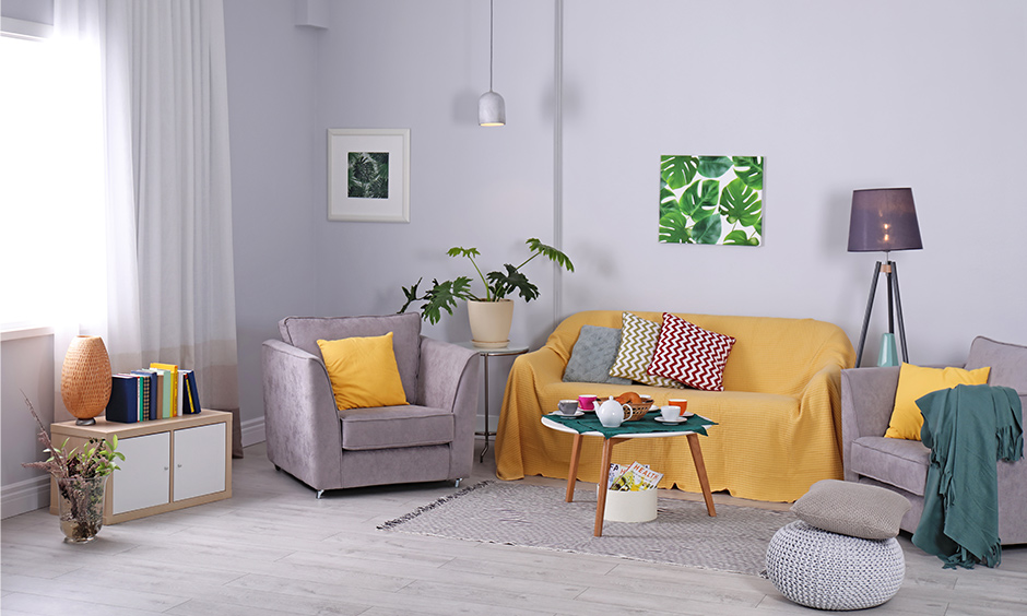 Living room in lavender pastel wall colour with grey & yellow sofa & coffee table looks stunning.