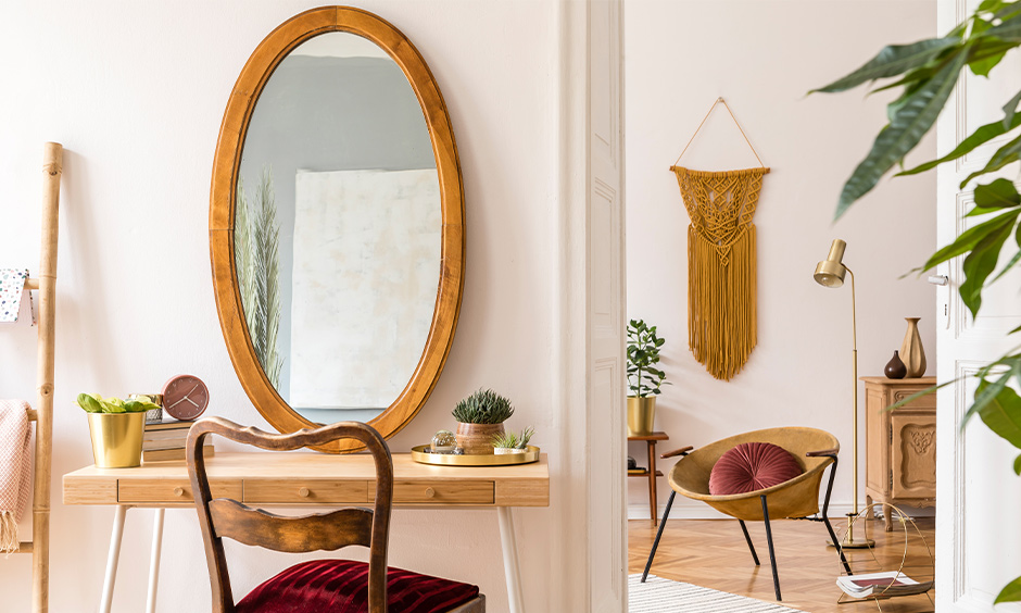 Oval mirror shaped dressing table design with wood, and matching chair with a soft velvet cushion is spectacular.