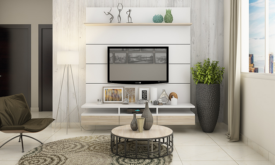 TV-unit against the wall with wooden panels adds lovely structure to the accent wall for white living room.