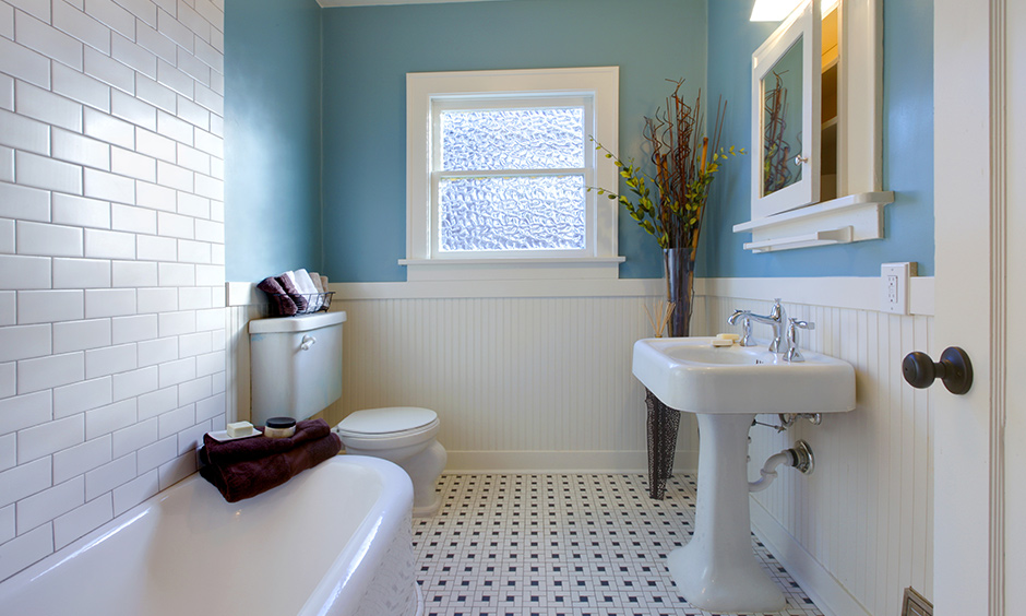 Bathroom in pastel blue wall paint colour with white tiles is refreshing and brightens up space.