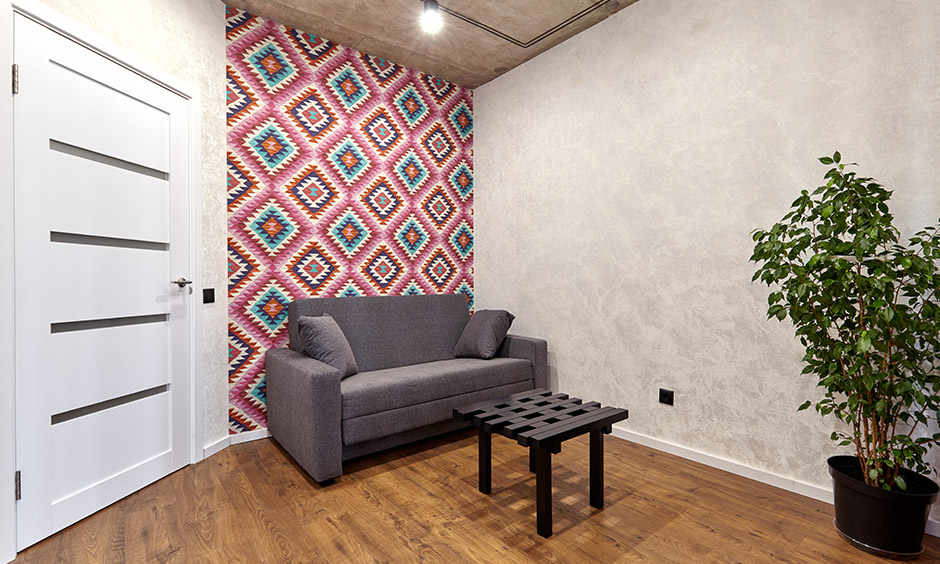 Quirky hallway wallpaper adds an exciting and fun vibe to the hallway with a sofa.