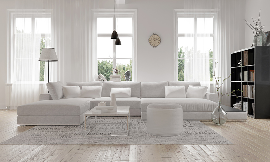 Sectional u-shaped white leather sofa in this white living room is perfect for a big family.