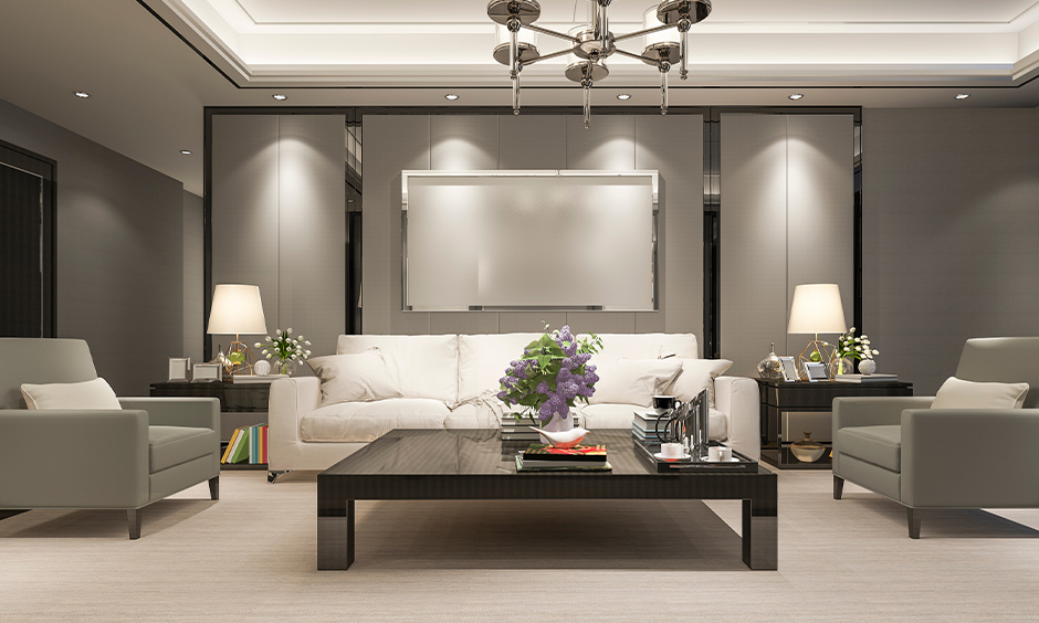 Neutral coloured lobby interior design with grey and white sofas, coffee table & chandelier, look simple classic.