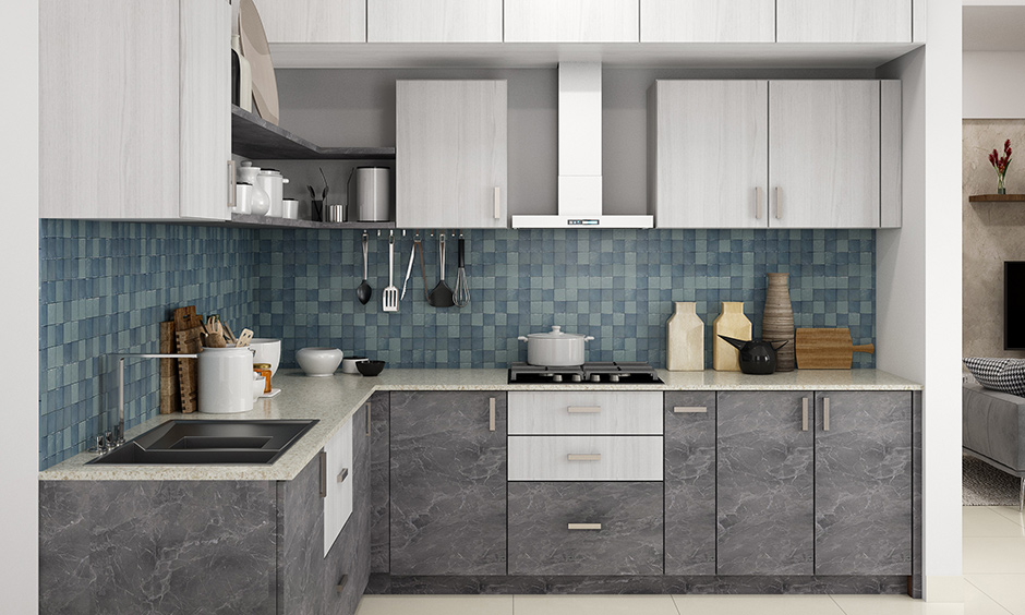 Kitchen setup for small house with blue mosaics backsplash, open shelves, cabinets & white granite countertop look elegant.