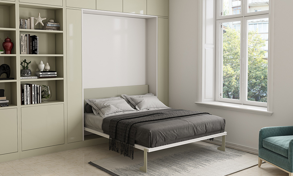 This white bedroom has a murphy bed for saving some floor space is the best 1bhk flat interior design.