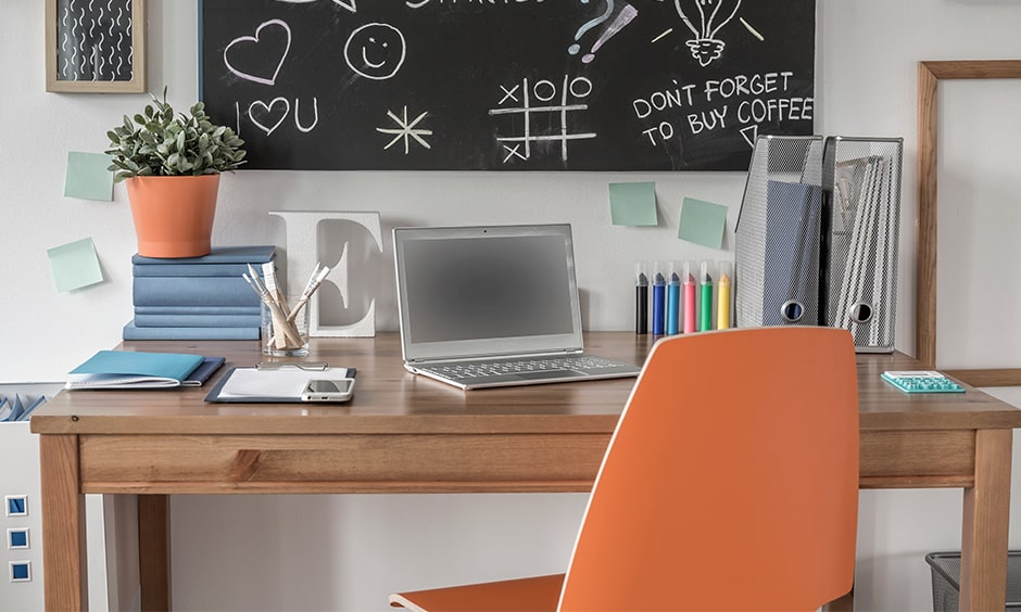 Study table wall decor with an orange chair and wooden study table