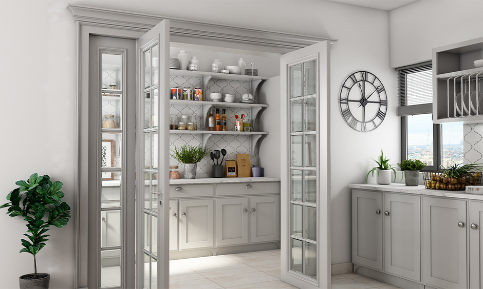 White kitchen with a three-layered wall shelf rack to store jars & containers is a beautiful kitchen wall shelf design.