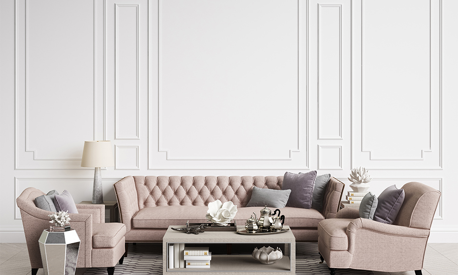 Beige coloured tufted sofa and two armchairs add a royal touch to the room is the best sofa design for small living room