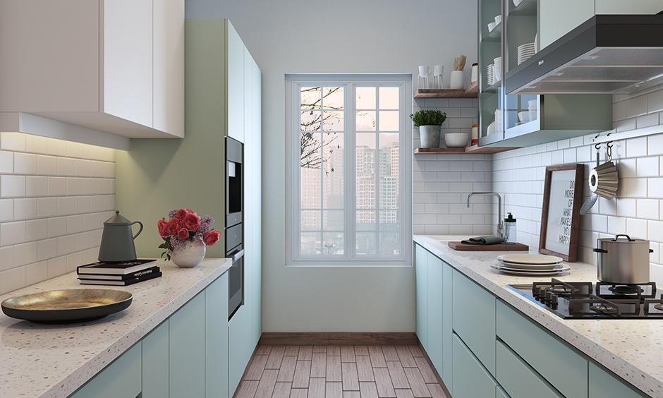 A cosy and lovely pink coloured cabinet attached beside the window on wall cabinets of a small parallel kitchen design