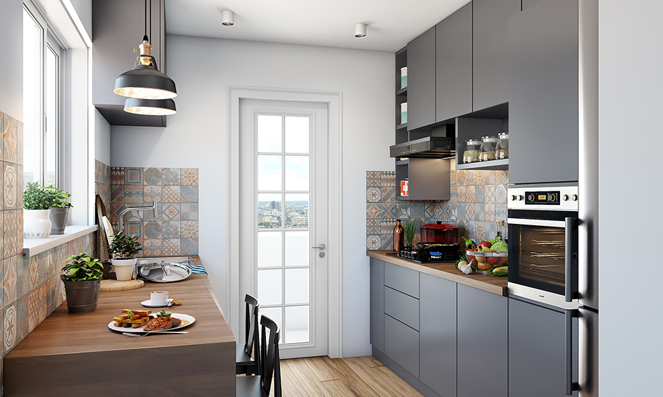 A grey fell parallel modular kitchen with a big window on a large countertop made up of wood