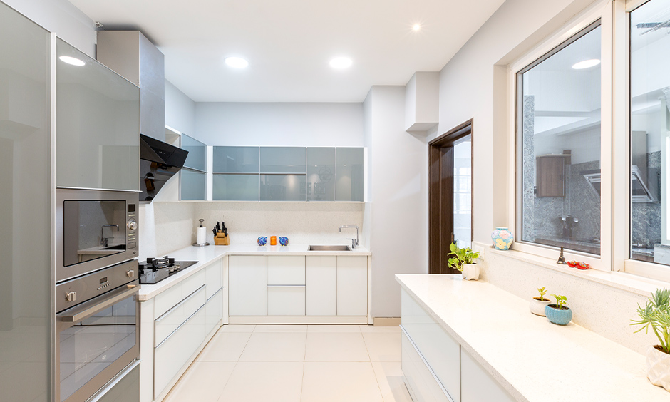 The white kitchen has pure white granite countertops easy to maintain and has an incredible sheen.