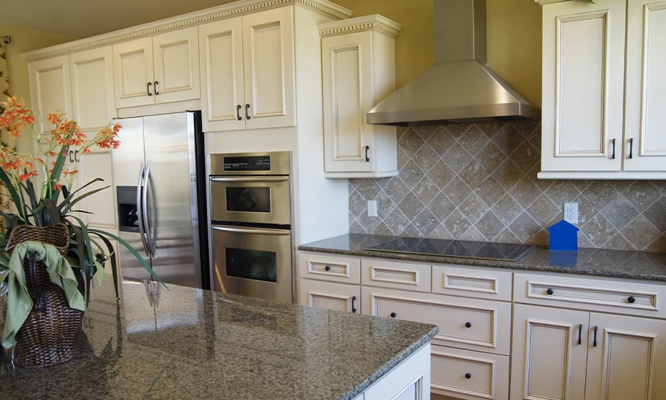 Grey granite countertop with white cabinets