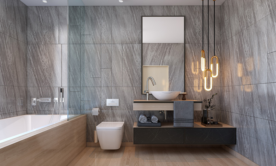 This modern bathroom has hanging led ceiling lights for the home next to the mirror that looks luxurious.