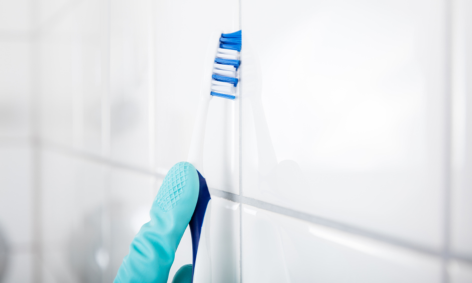 How to clean grout in kitchen wall tiles use of a toothbrush with a mix of baking soda and vinegar.