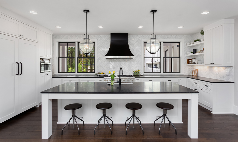 White island kitchen colour schemes with black countertops bring a modern touch to the kitchen.