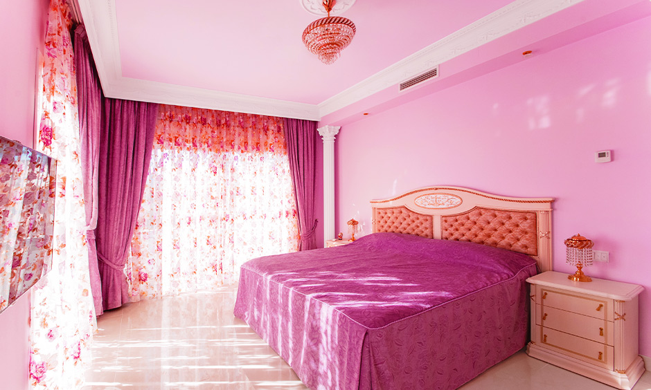 Pink colour bedroom with fall ceiling paint in pastel shades makes it more refreshing to the room.