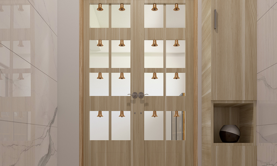 Simple pooja room door designs with glass which reflects more light in the pooja room