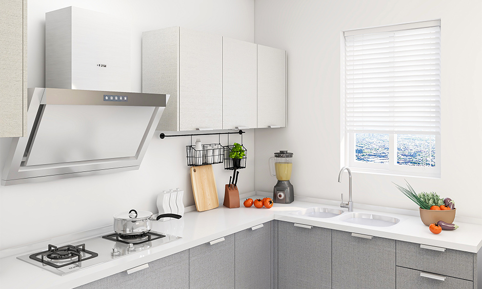 Two burner kitchen hob and chimney is scratch-proof and easy to clean in this white kitchen and cabinet in grey colour.