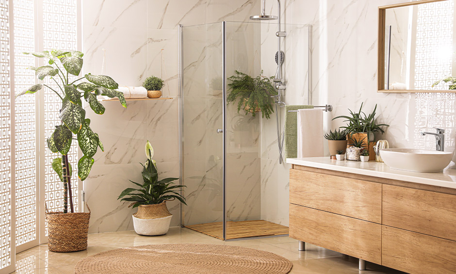 Glass enclosure shower and a plethora of planters around creates a natural bath with bohemian contemporary bathroom interiors.