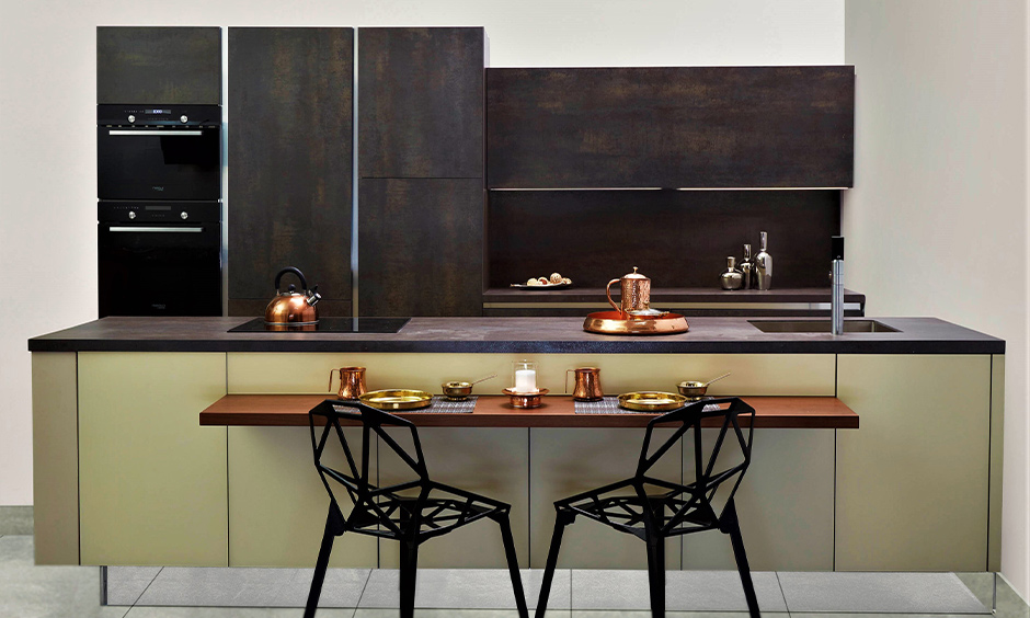 Brownish-grey soapstone countertops blends well with the dark brown kitchen cabinets