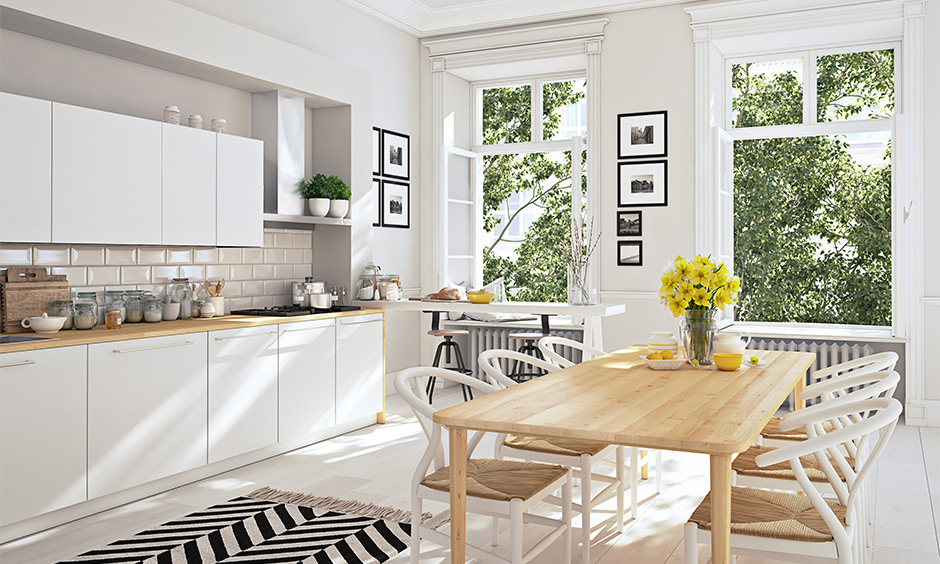 This dining cum white contemporary kitchen design with two windows brings in all the light and hassle-free.