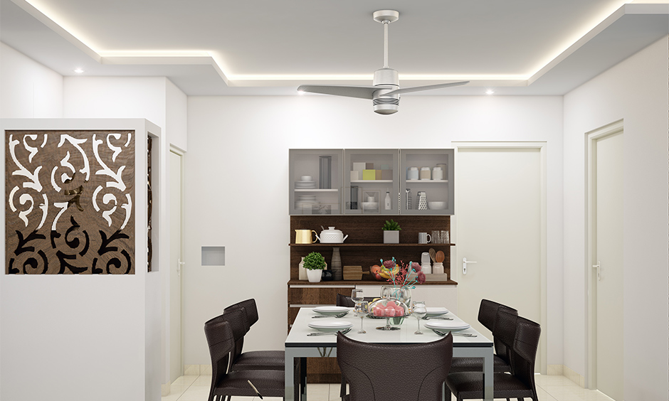 White dining room false ceiling designed with cove lighting is perfect for an excellent experience for a party.