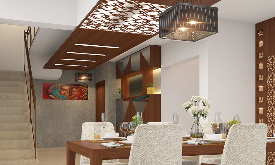 Dining room ceiling design made using timber and glass combination in an intricate pattern with hanging light looks rustic.