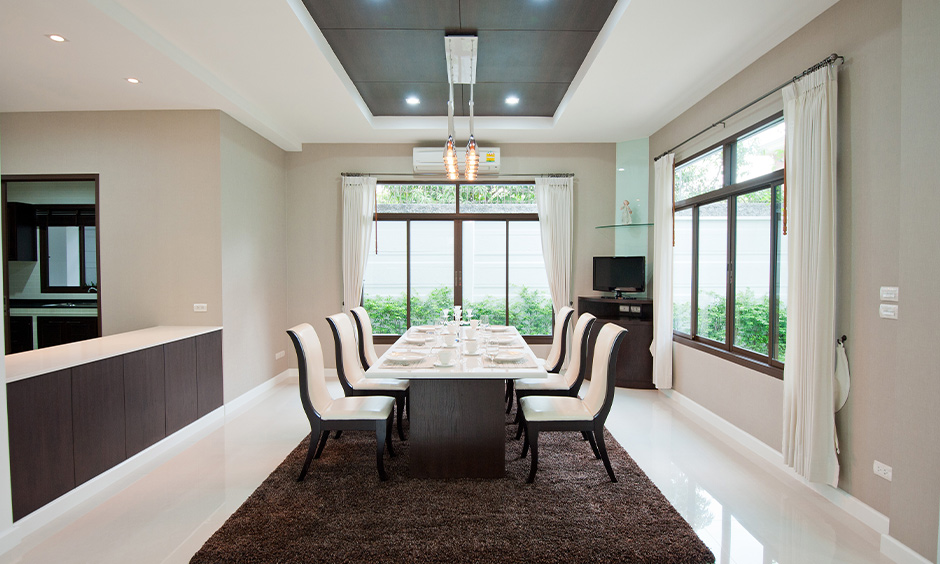 Hanging dining room lights adding vibe to a six-seater table in white