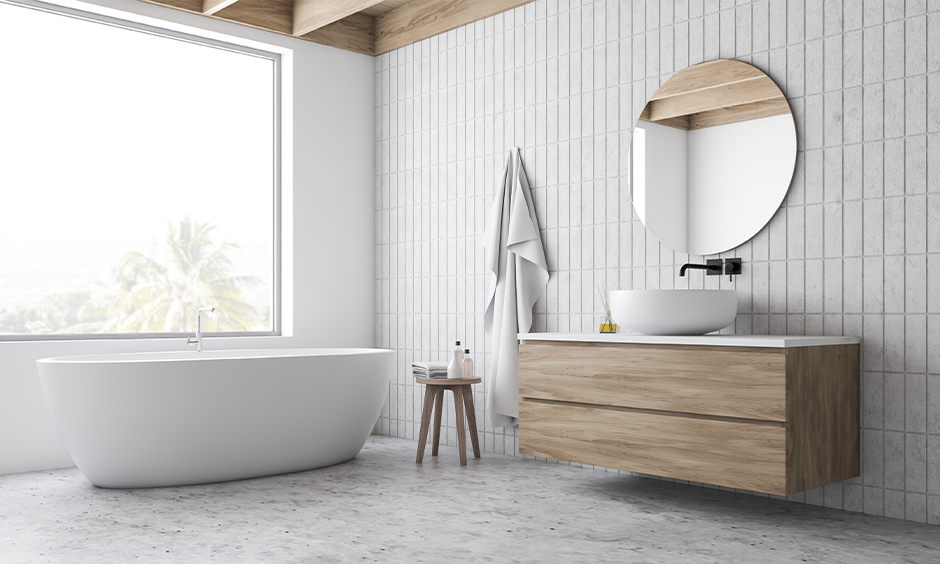 Minimalistic white contemporary master bathroom with a sleek mirror below wooden cabinet and zen bathtub looks seamless.