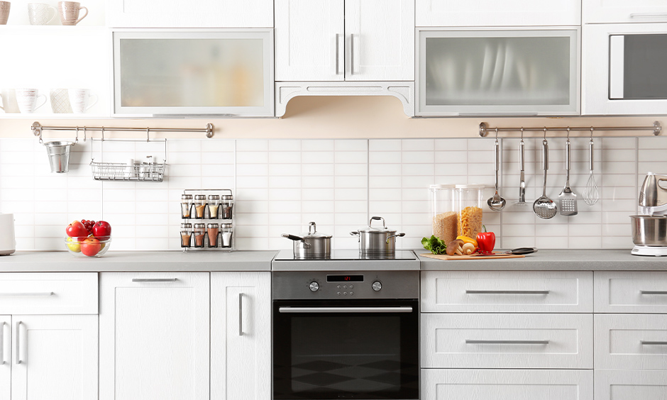 White kitchen with a modern technology induction cooktop that enhances the elegance of the area is the best kitchen hob.