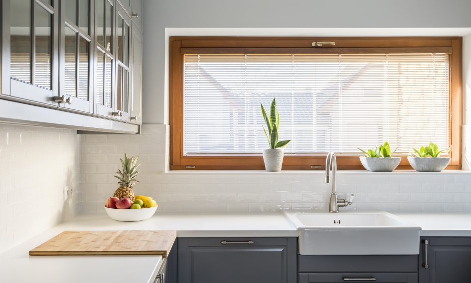 Small kitchen with wooden frame window truly stands out as an iconic focal point is the kitchen window design India.