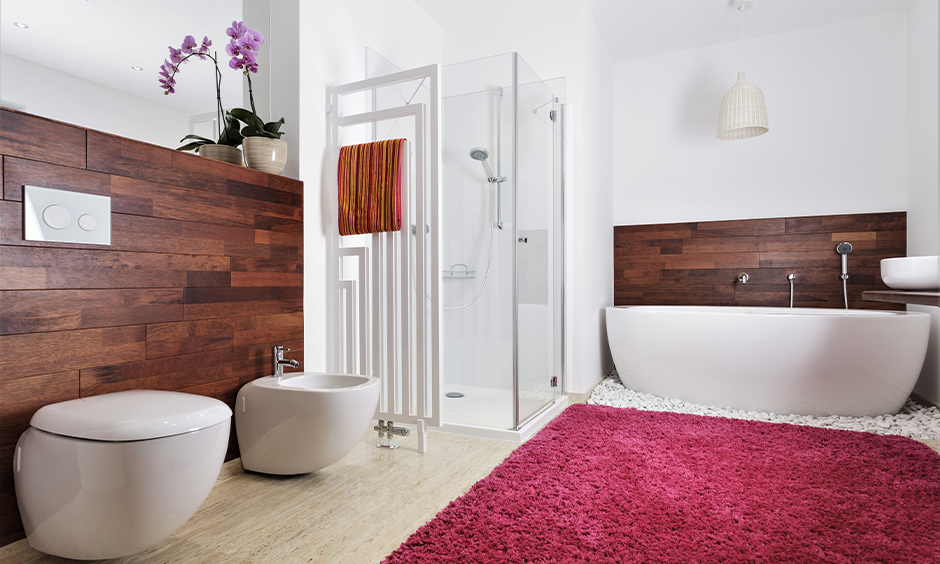 Kida bathroom idea with medium-sized pink and white-coloured rug and wooden panels on each side is a little girl bathroom decor.