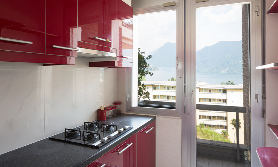 Cabinets laminated in red kitchen design with a black countertop