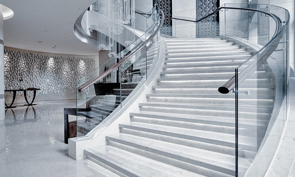 Spiral staircase design with glass railing and steel handrail