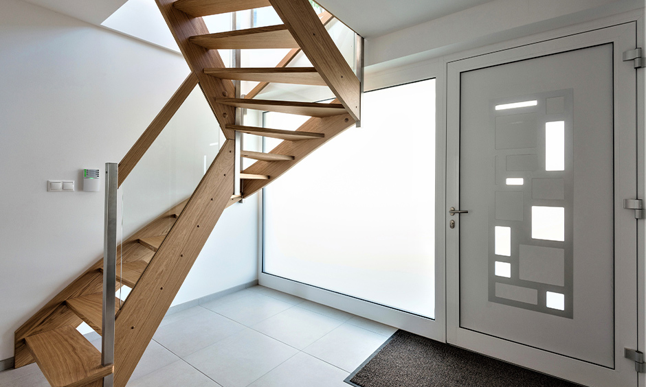 Steel and glass wood staircase lend a modern yet mid-century vibe to the hallway interiors.