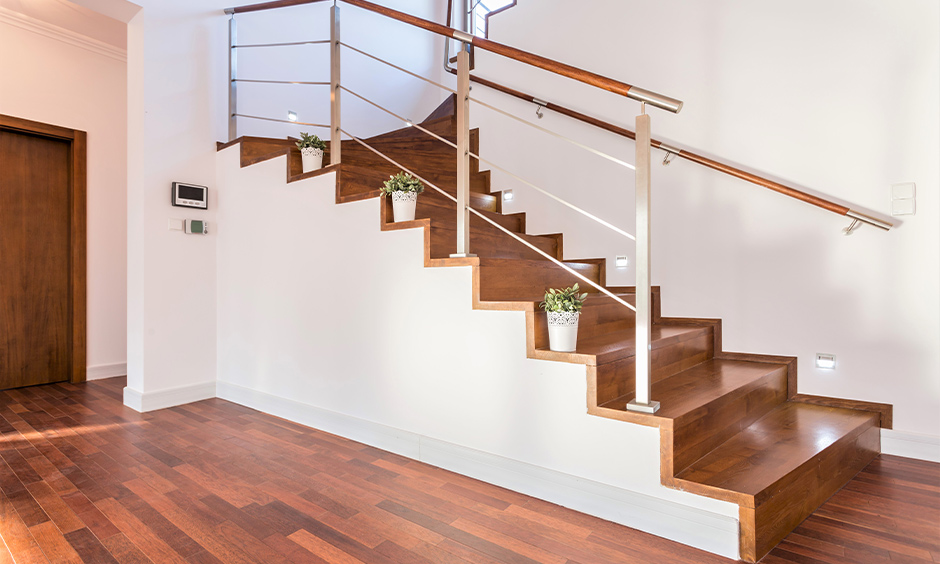 Steel rod-style with modern wood stair railing is the simplistic beauty of this entrance hallway excited.