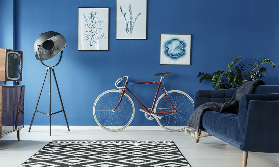 This stylish round lamp against the blue wall is the best lamp for the living room and looks elegant with a sofa.