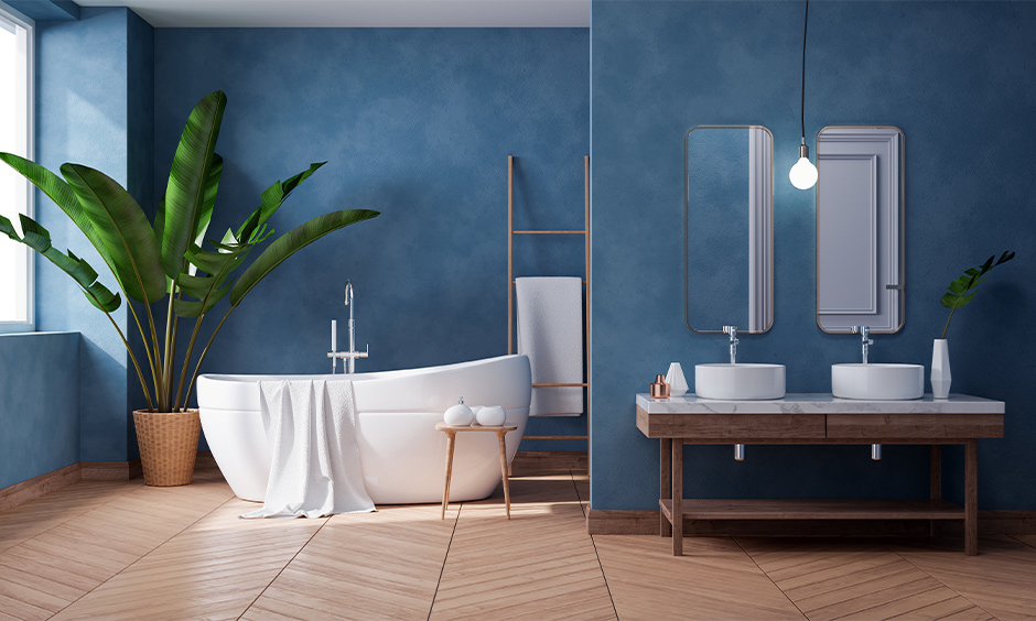 Blue and cool white tropical contemporary bathroom designed with the luxe fittings and indoor planters looks soothing.