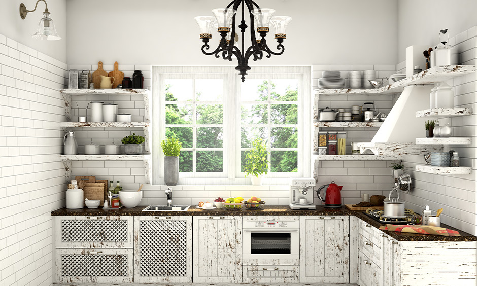 This vintage l shaped kitchen design with the window in white makes the joy of cooking feel and look chic.