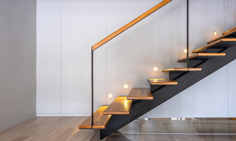 Wooden staircase with inlaid LED lights fitted into the wall embellishes a modern home is the staircase lighting ideas.