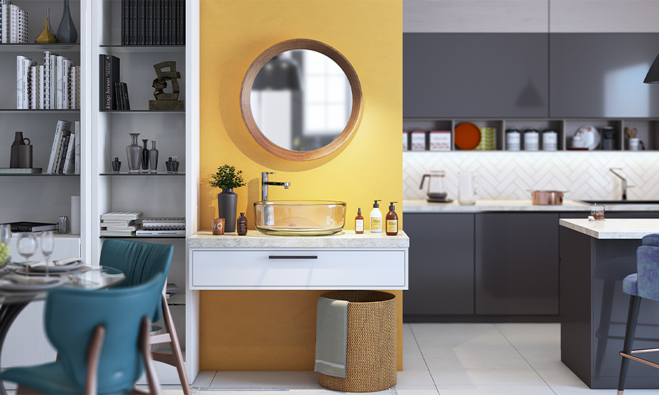 Classy glass washbasin design in dining room rests on a white marble top against a yellow background simplistic yet stylish.