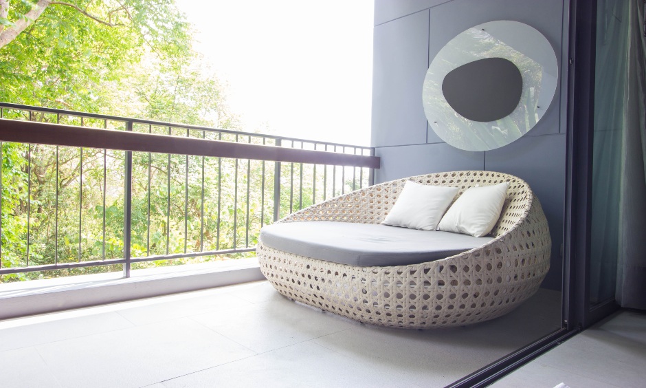 Balcony grey wall with a bold piece of decor in a minimal and classy design is the balcony sidewall design.