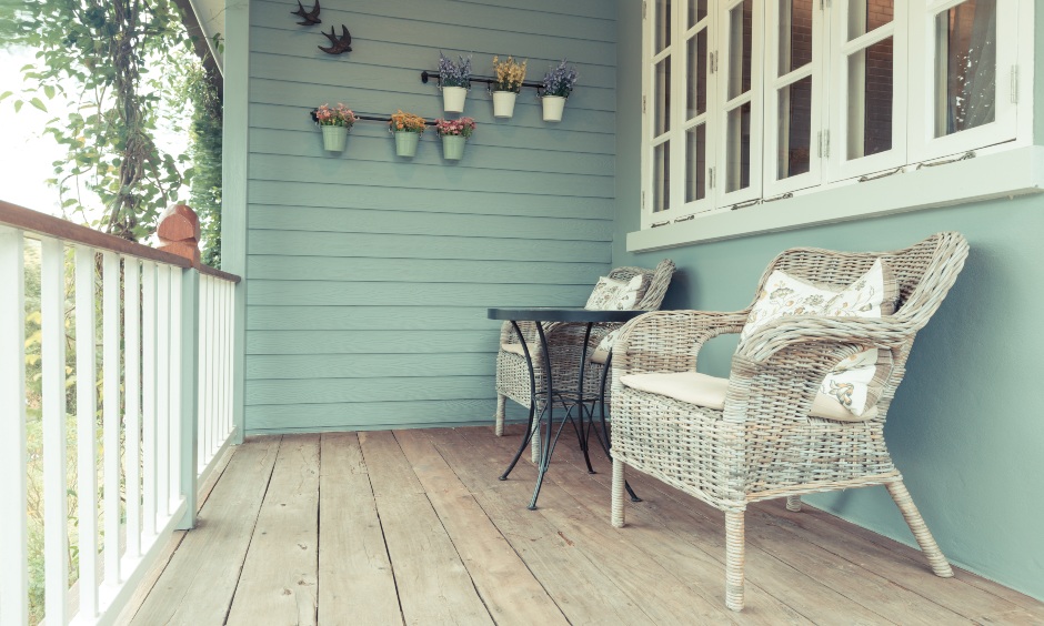 Front balcony wall design with small planters installed, the wall has classic wood paneling that looks bright and cheerful.