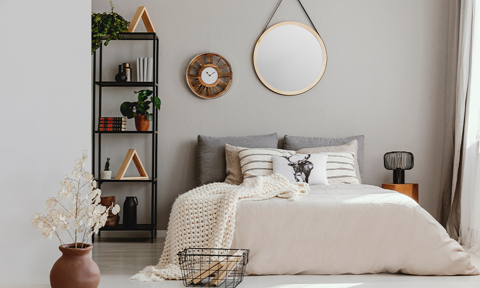 Functional bedside corner shelf made from wrought iron and placed books, vase and plants are corner shelf ideas for bedroom.