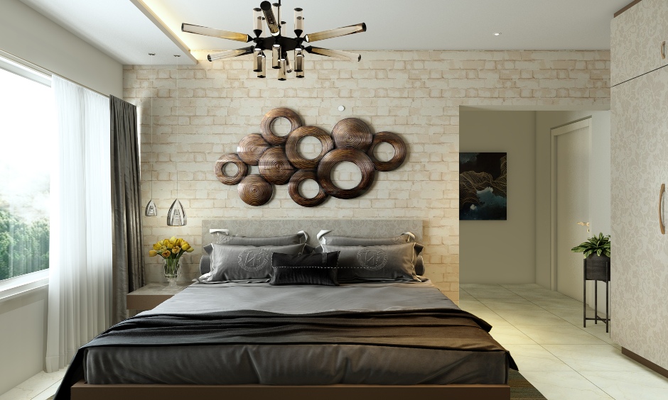 Elegant bedroom designed with a stone wall cladding tiles in a light hue enhances the look of space.