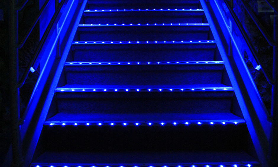 Staircase with tiny blue neon light strips adds an element of fun to space is led lights for staircases idea.