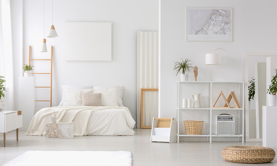 All-white bedroom corner shelf idea, minimal shelf made from wood and painted in white brings elegant to space.