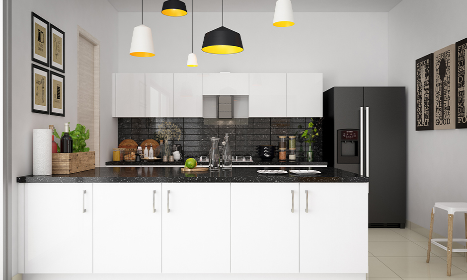 One wall small open kitchen design with the living room in white colour is clean and looks organised.